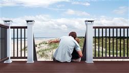 Deckorators_CXT_Pro_Colonial_Composite_Brown_Bronze_Rails_With_White_Posts_Solar_Post_Caps_Ocean_Beach_View_Non_Corrosive_Deck_Railing